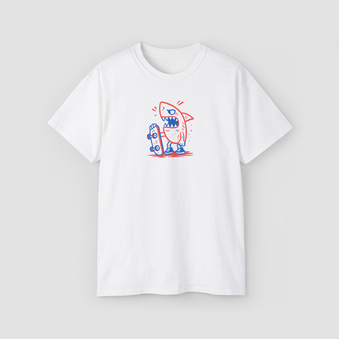 A cool cartoon shark on a skateboard graphic, minimalist design on a 'Skate Shark' white oversized t-shirt.\