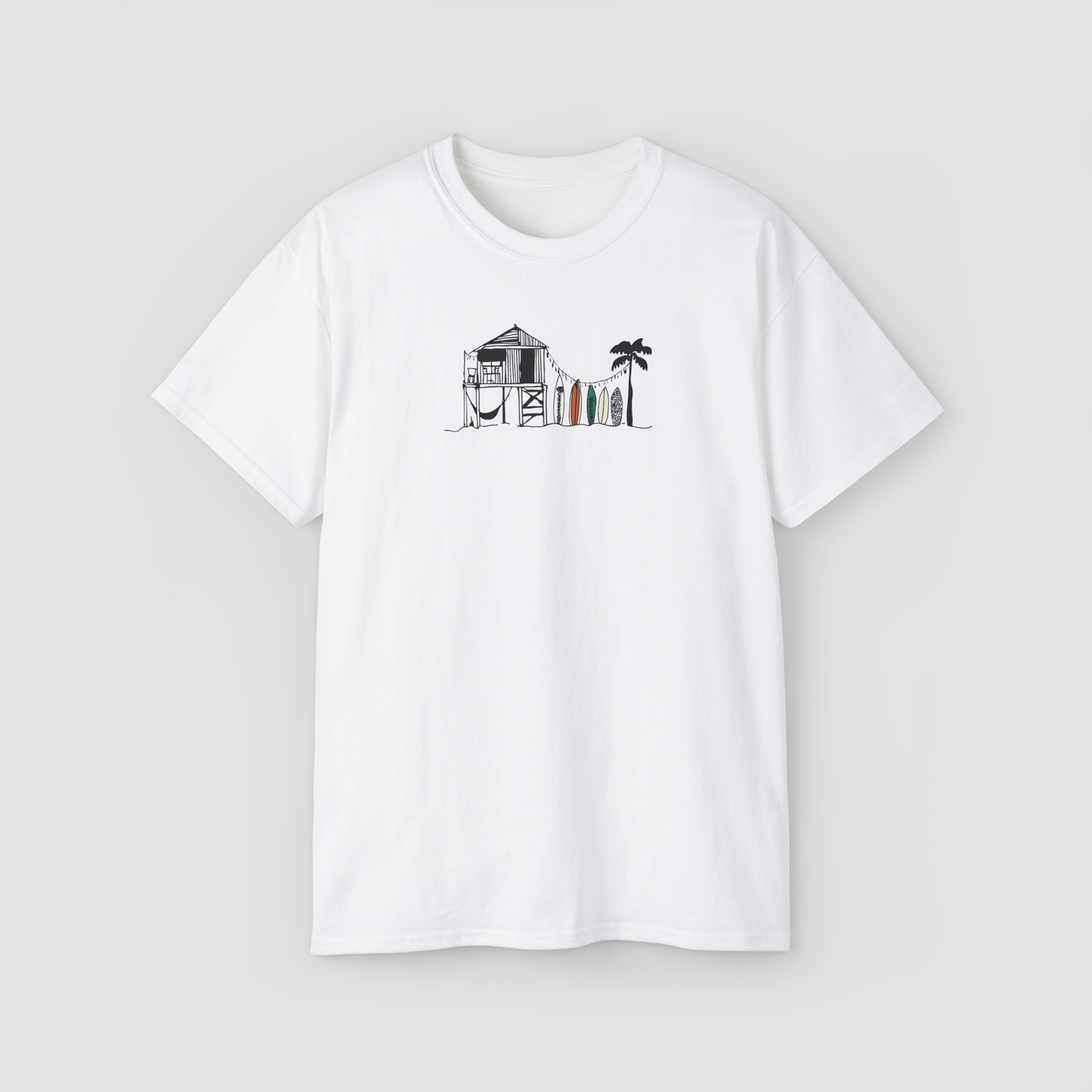 The Beach Shack' minimalist line art graphic of a surf shack on a white oversized t-shirt.\
