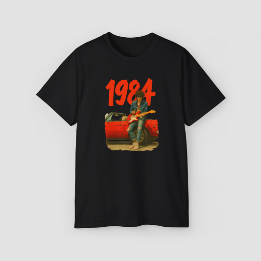 Greatest Year 1984' retro graphic with a vintage car and figure on a black oversized t-shirt.\