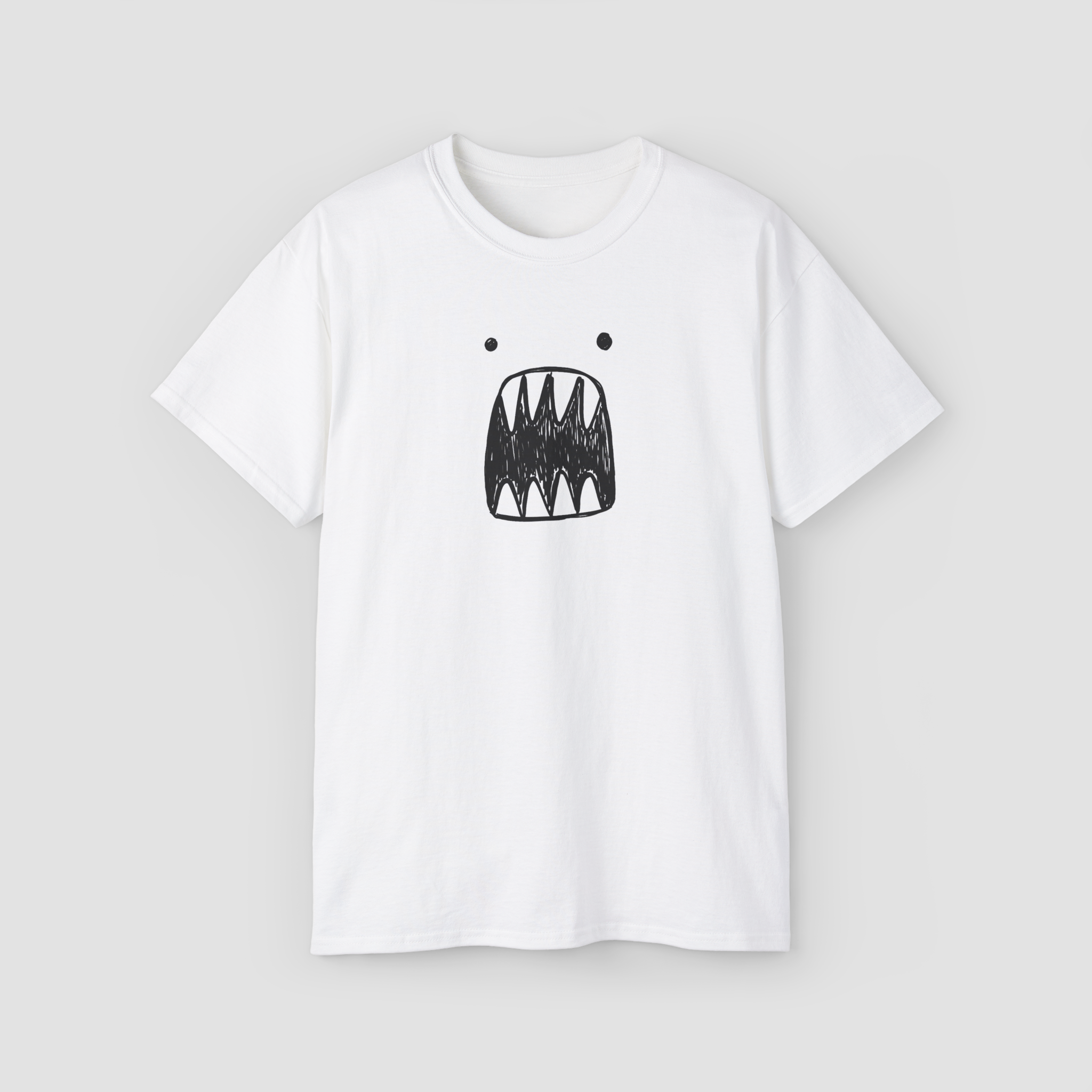 A quirky and minimalist scribble monster face graphic on the 'Scariest Tee' white oversized t-shirt.\