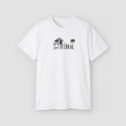 The Beach Shack' minimalist line art graphic of a surf shack on a white oversized t-shirt.\