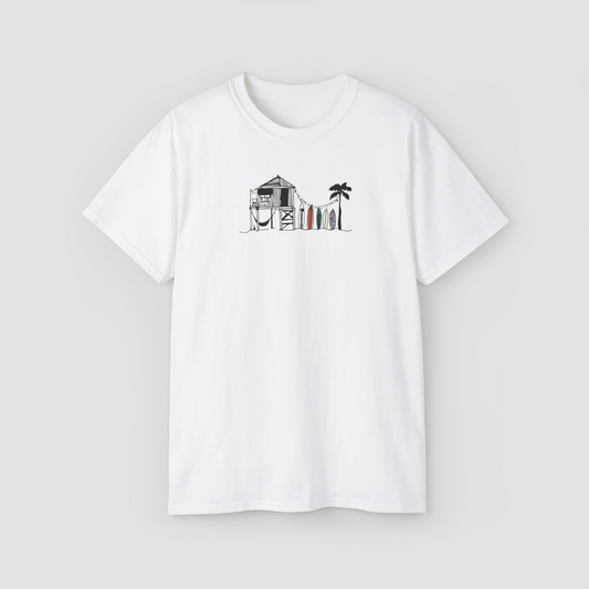 The Beach Shack' minimalist line art graphic of a surf shack on a white oversized t-shirt.\